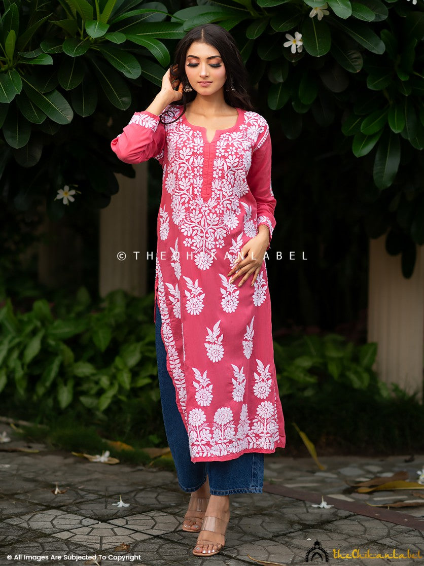 Woman wearing peach straight-fit kurti paired with white embroidered palazzos