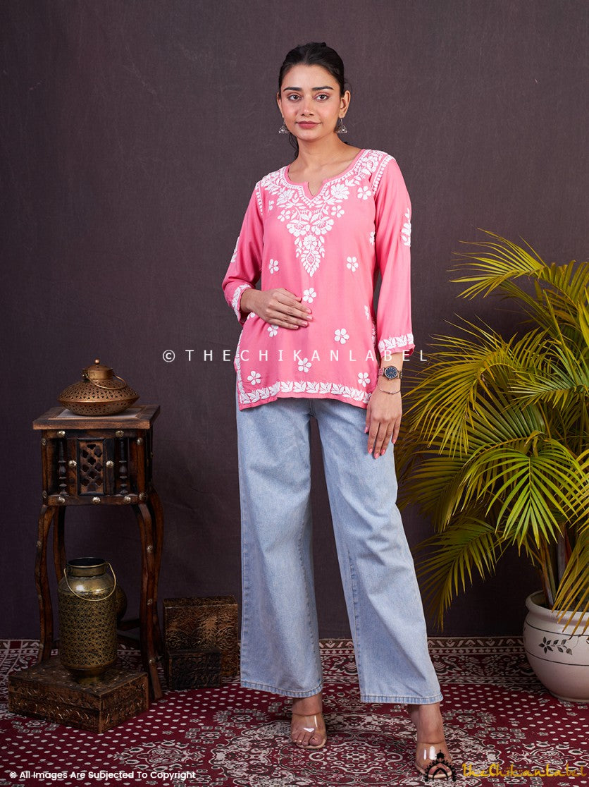 Hand-embroidered peach cotton top with white floral motifs