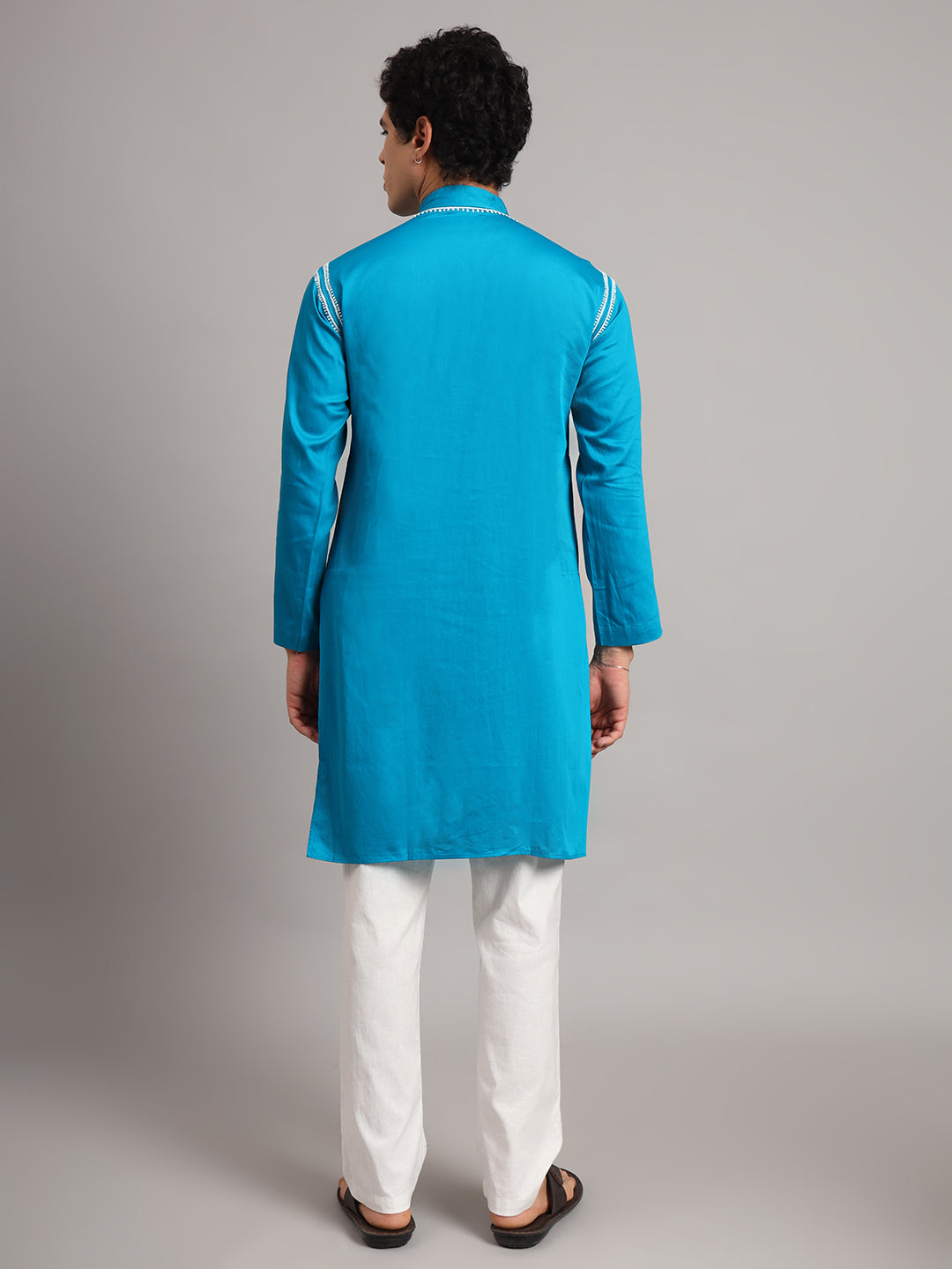 Front view of the Uman Mens Kurta highlighting the symmetrical neckline embroidery, short button placket and straight silhouette falling around the knees.