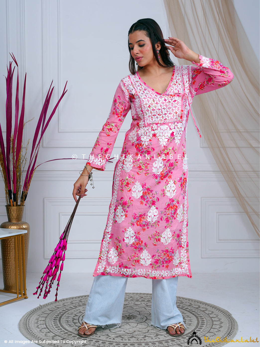 Woman wearing pink mulmul chikankari kurti with white floral embroidery