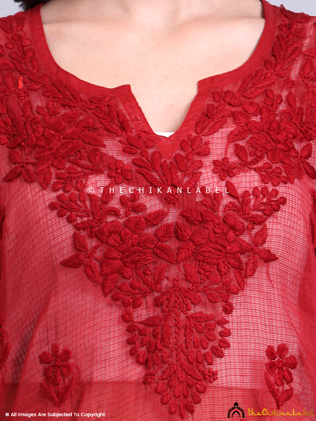 Front view of a traditional Kota cotton short kurta featuring intricate floral Chikankari embroidery.