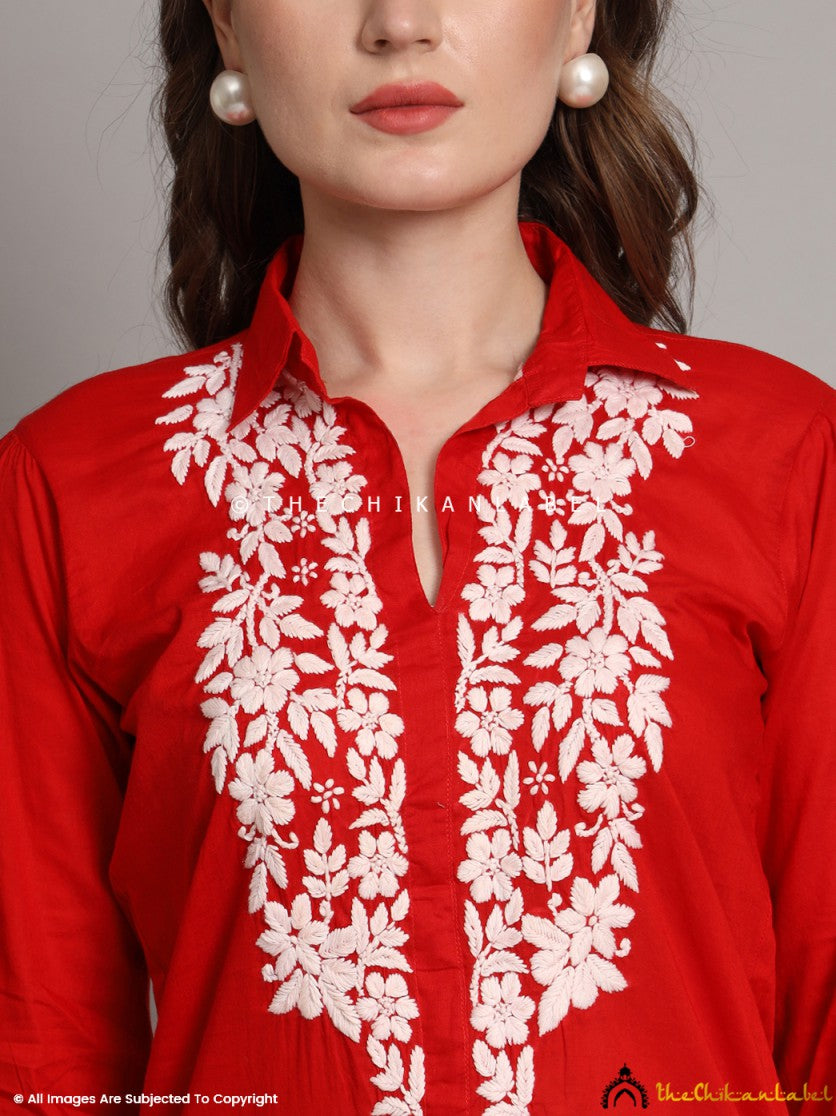 Front view of hand-embroidered floral chikankari design on red shirt