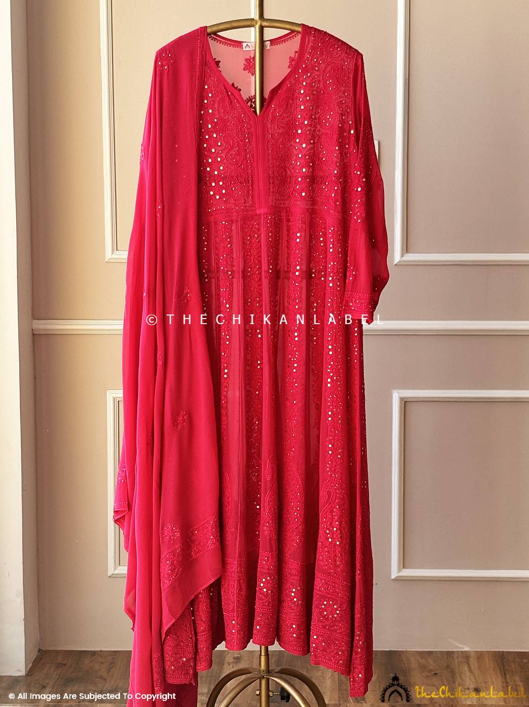 Red Anarkali chikankari suit with mirror work on hanger