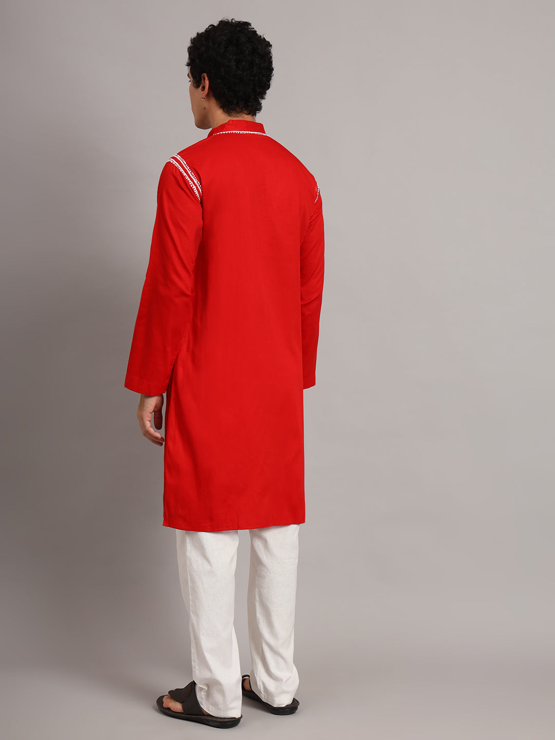 Front view of the Uman Mens Kurta highlighting the symmetrical neckline embroidery, short button placket and straight silhouette falling around the knees.