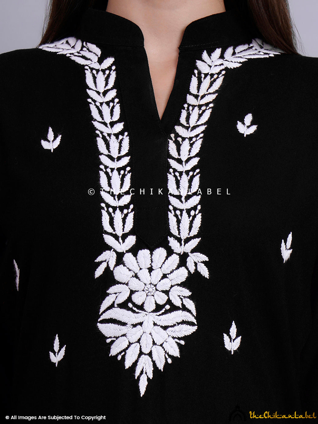 Full-length image of a model showcasing elegant hand-embroidered chikankari kurti with detailed neck and sleeve embroidery.
