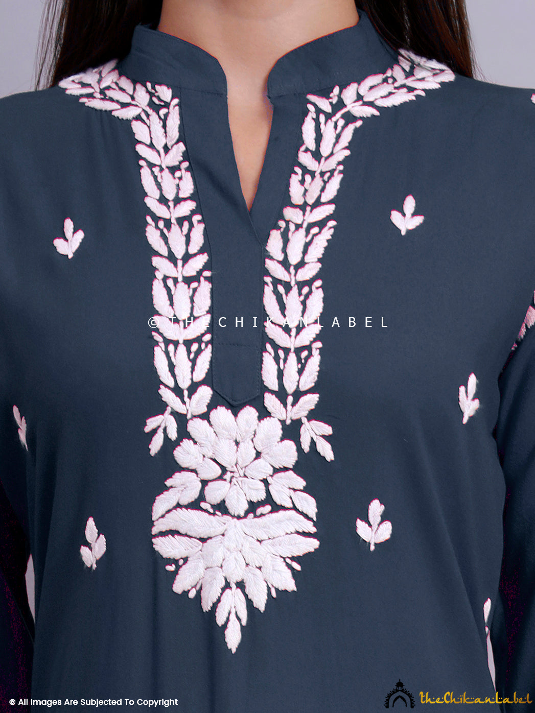 Model in rayon chikankari kurti styled with flared bottoms and traditional jhumkas.