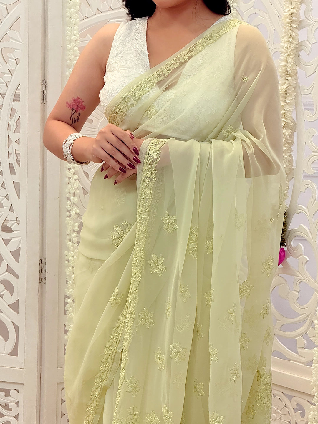 Traditional Lucknowi chikankari saree made from lightweight georgette fabric with handcrafted floral motifs.