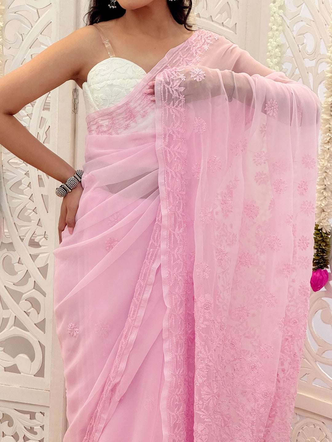 Festive wear georgette saree featuring intricate Lucknowi embroidery crafted by skilled artisans.