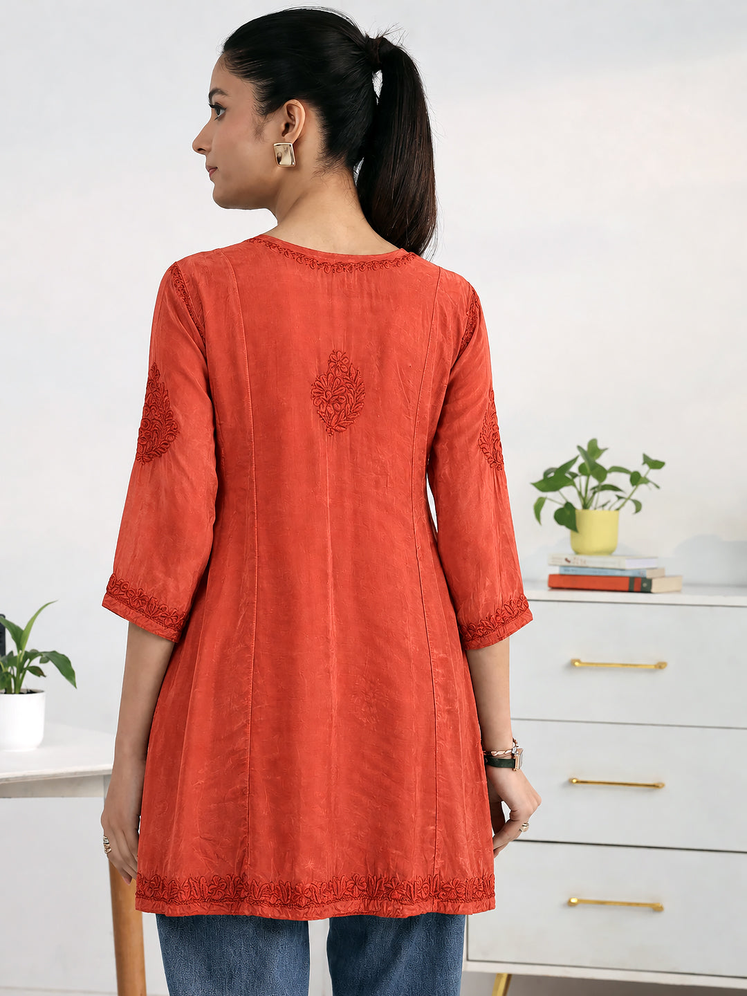 Festive wear Chikankari short kurti for women with traditional floral thread embroidery, an elegant V-slit neckline, three-quarter sleeves, and a graceful flared cut.