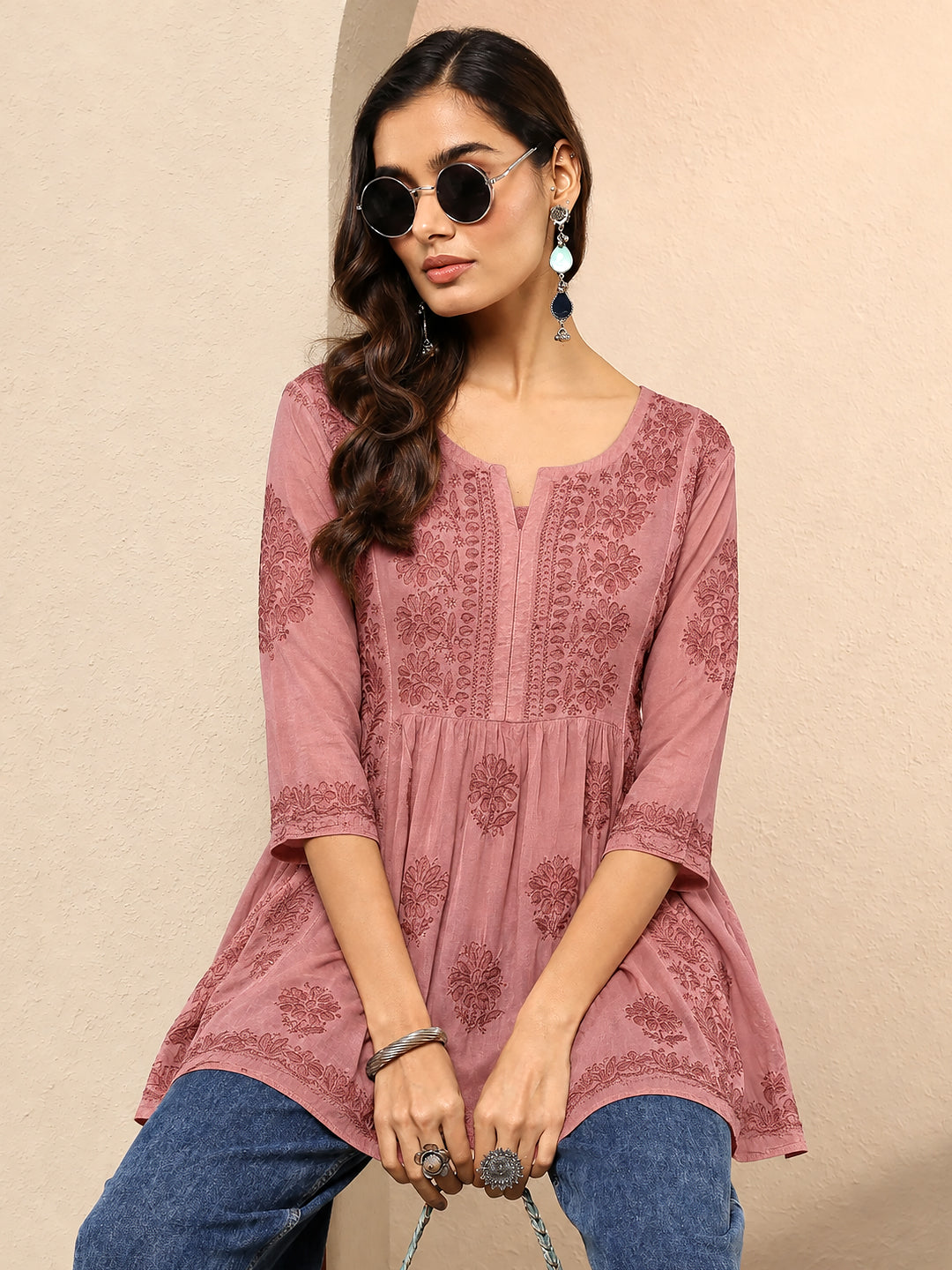 Sara Viscose Silk Short Kurti designed for festive occasions with intricate floral embroidery on the bodice, scattered motifs on the lower section, and decorative sleeve edges.