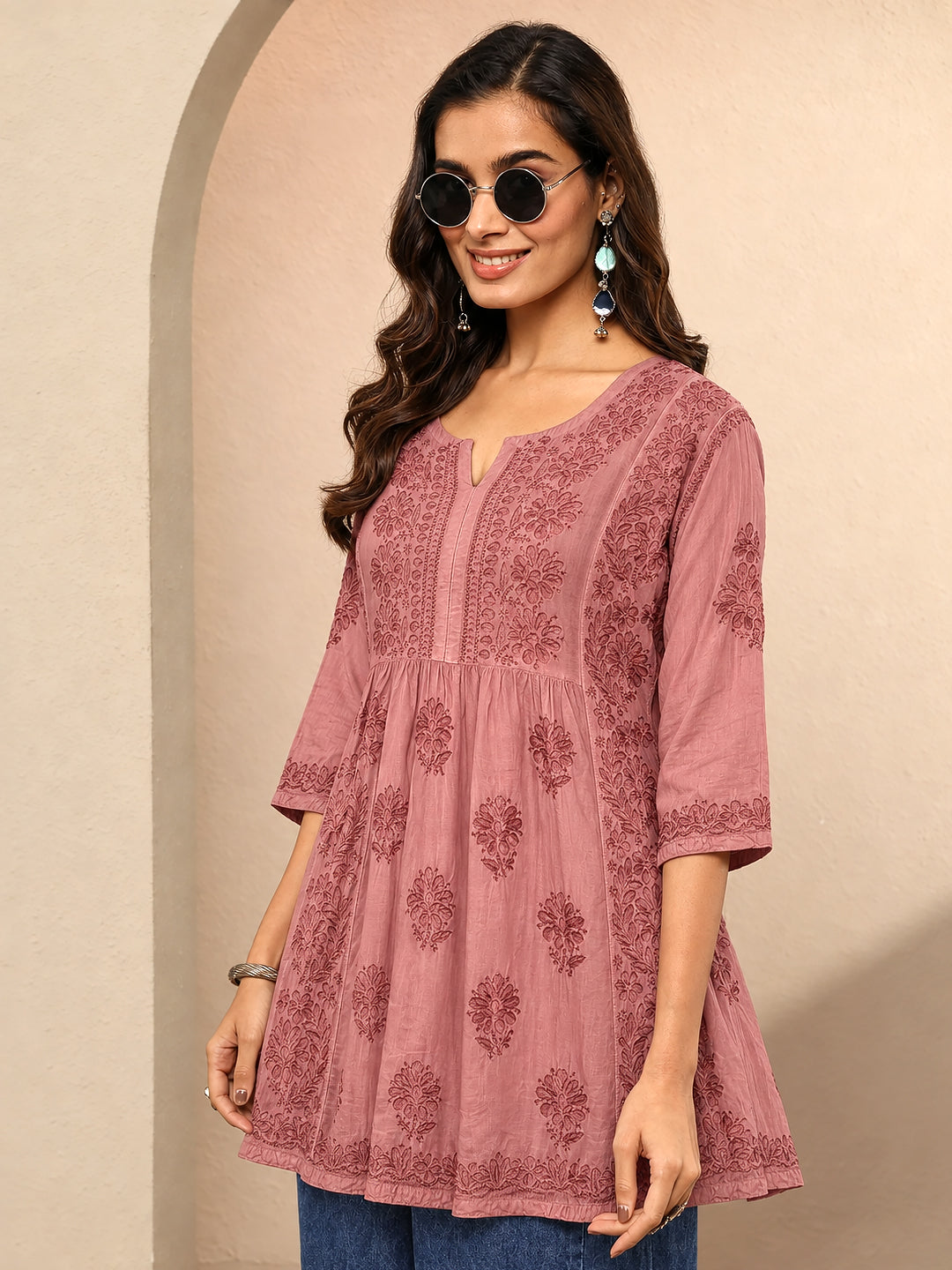 Detailed view of a women's Chikankari A-line kurti showing embroidered floral motifs, fine stitching along the neckline, traditional threadwork, and an ornamental hem border.