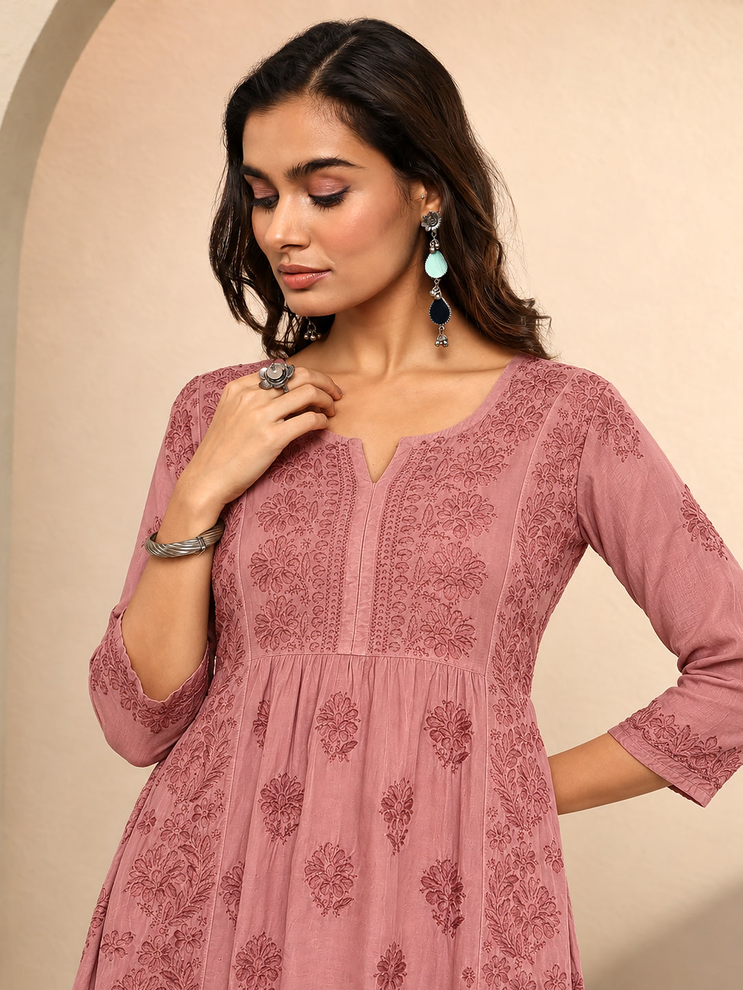 Traditional Indian Chikankari short kurti featuring all-over floral embroidery, delicate threadwork details, an elegant V-slit neckline, and a feminine silhouette for women.