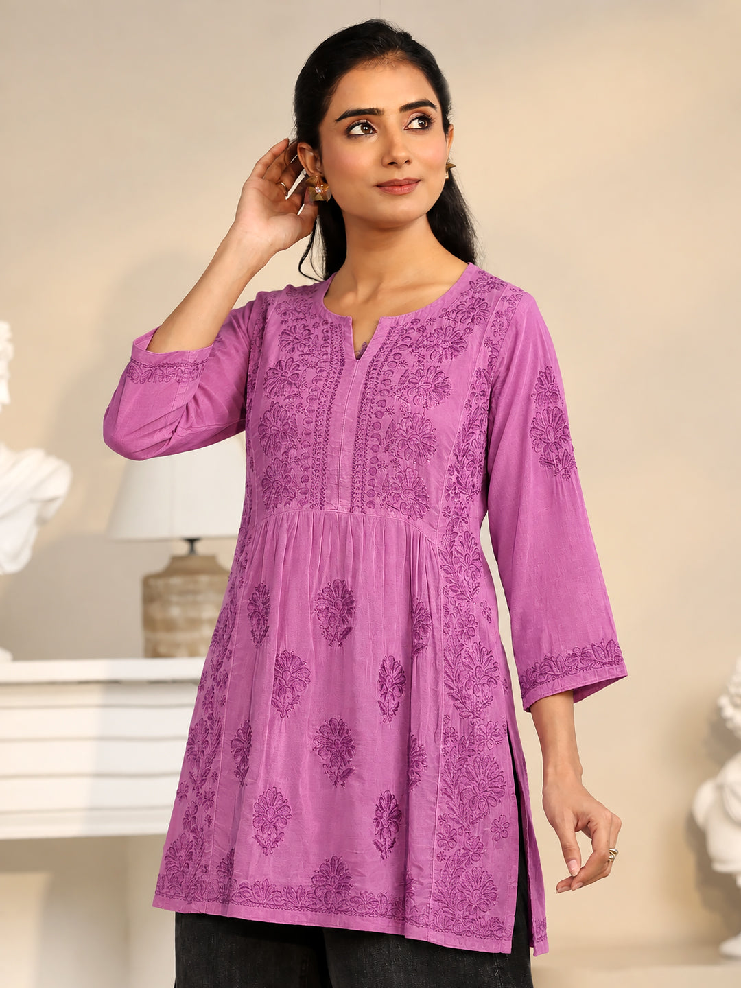 Sara Viscose Silk Chikankari Kurti displayed on a wooden hanger, showcasing its embroidered front panel, floral motifs, elegant sleeves, and traditional Indian craftsmanship.