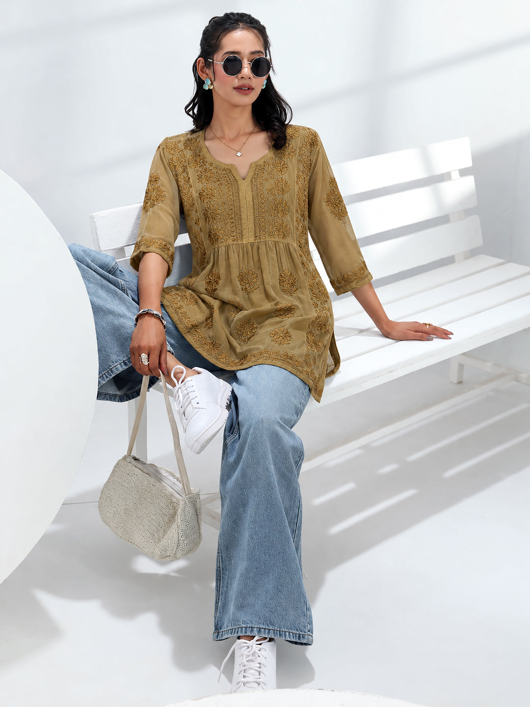 Trending Chikankari short kurti for women designed with delicate floral embroidery, a flattering A-line fit, three-quarter sleeves, and a stylish neckline for versatile ethnic wear.