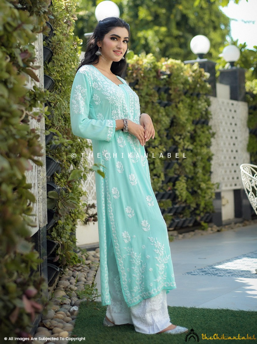 Hand-embroidered floral motifs on sea green kurti