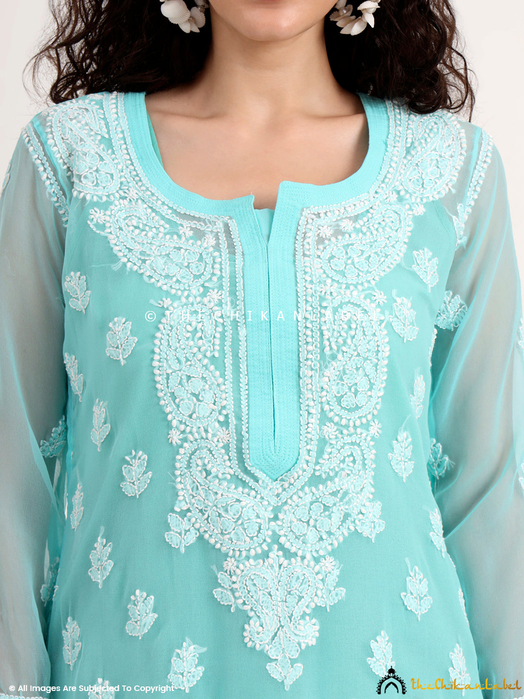 Woman flaunting a viral chikankari kurti, styled minimally with oxidized earrings and flats—perfect for college, brunch outings, or comfortable everyday wear.