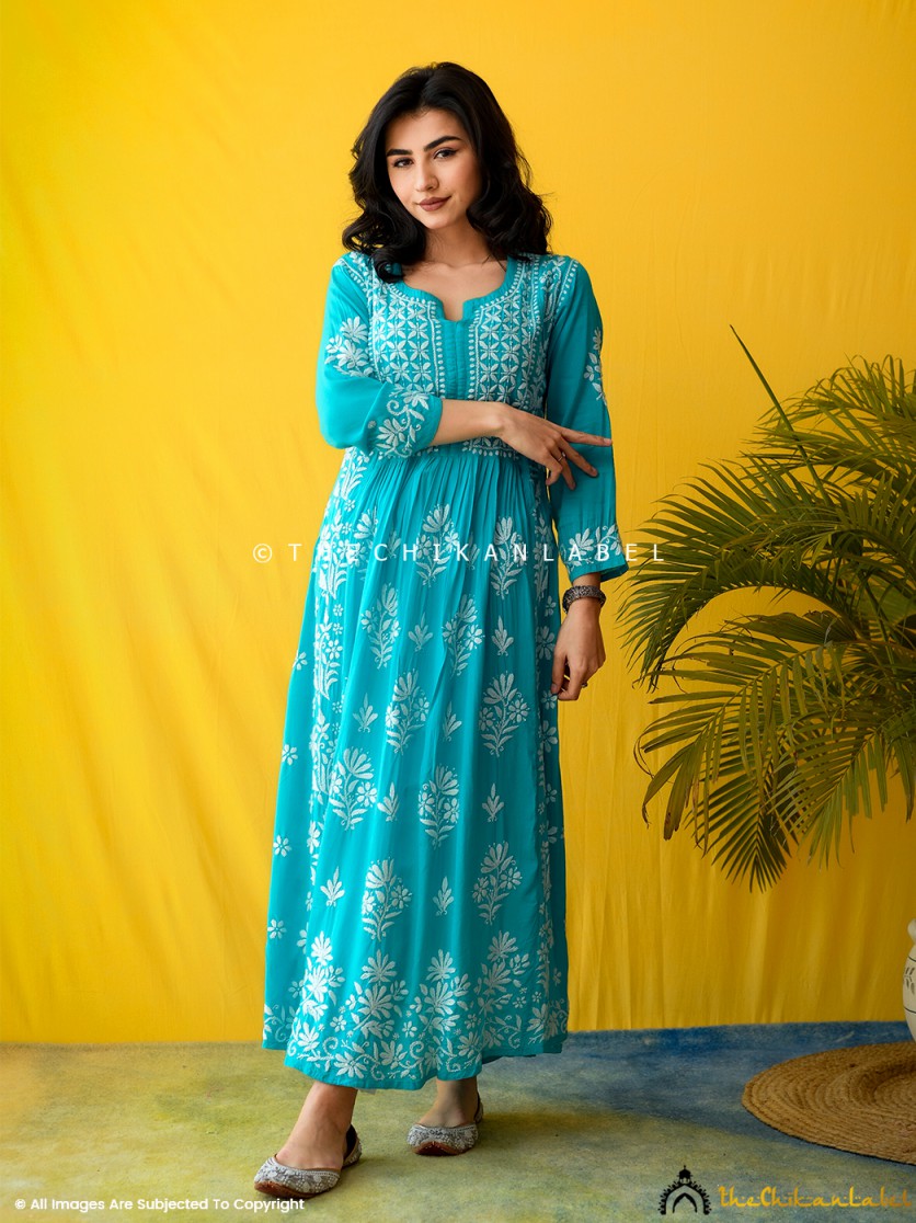 Woman wearing sea green A-line chikankari kurti with white floral embroidery