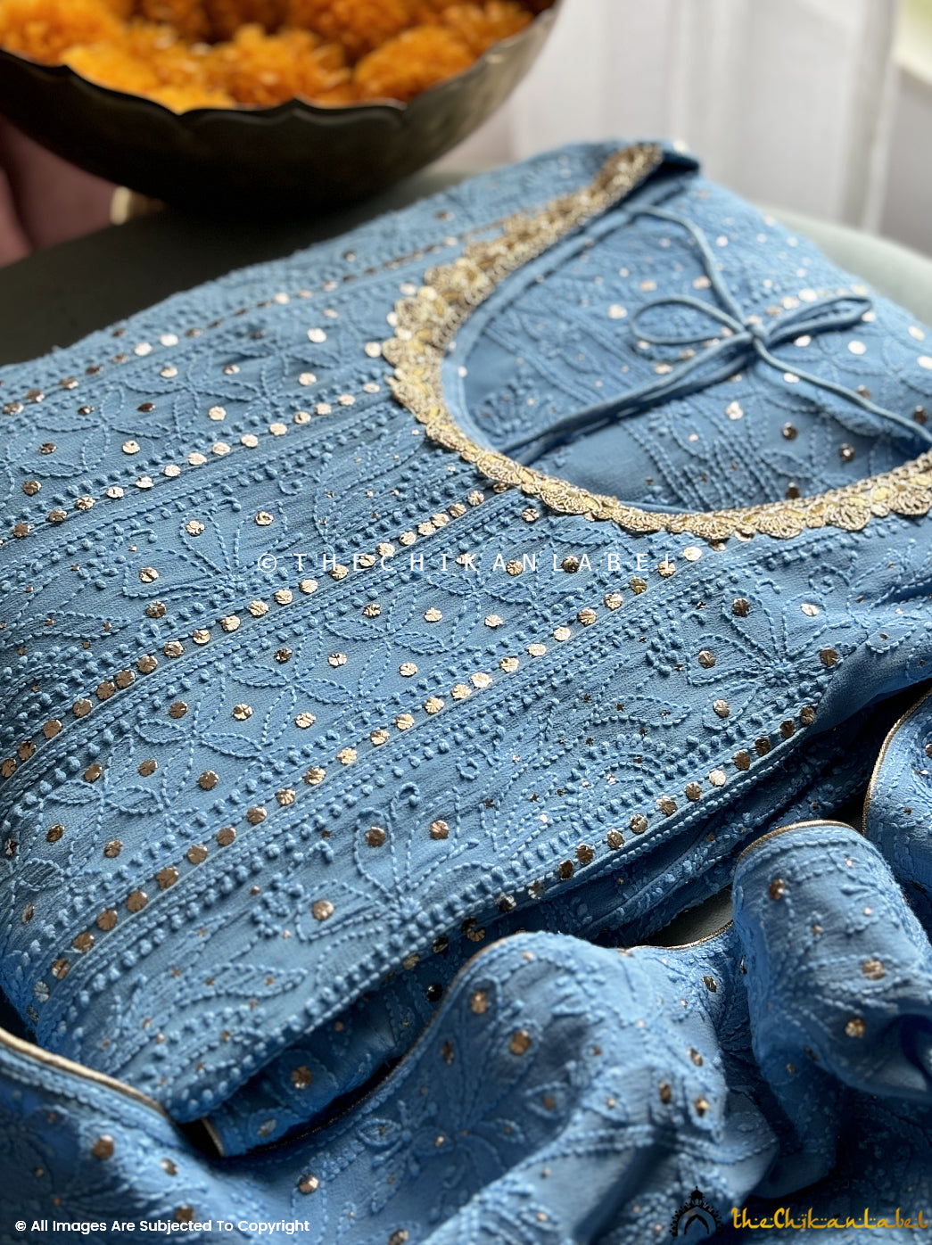 Artisanal mukaish Anarkali paired with classic Indian accessories in an outdoor festive setting