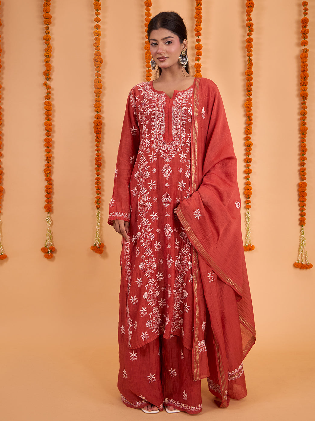 Sofia Mul Chanderi Kurta Set with Dupatta shown on a model, with full-length embroidered sleeves and palazzo pants finished with decorative hem borders.