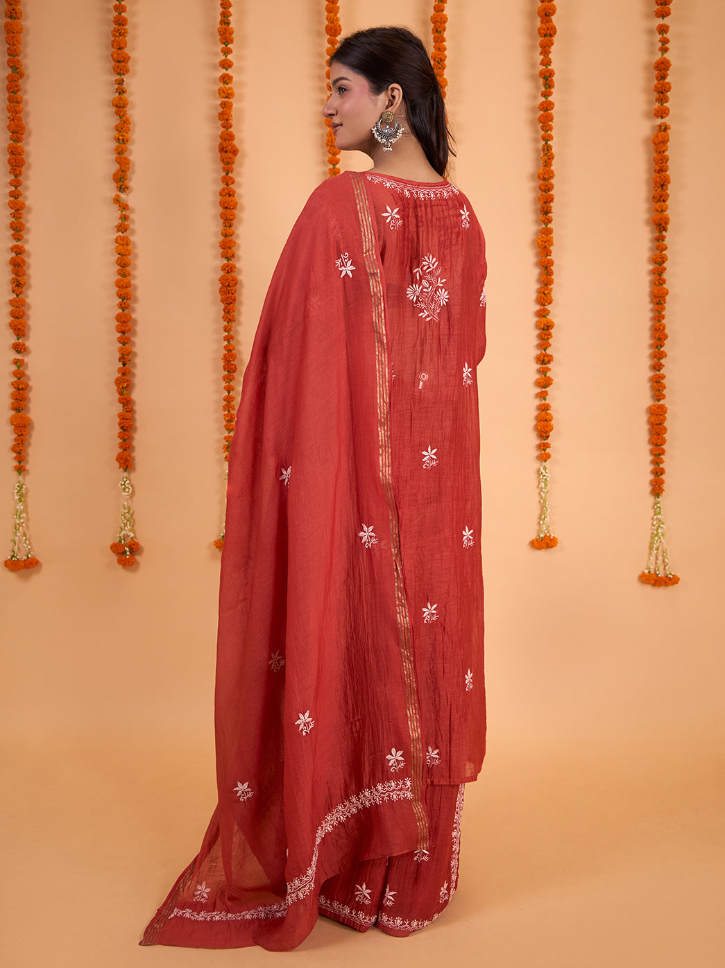 Model wearing the Sofia Mul Chanderi festive wear set, with detailed floral embroidery framing the kurta front and a coordinated dupatta resting over her shoulder.