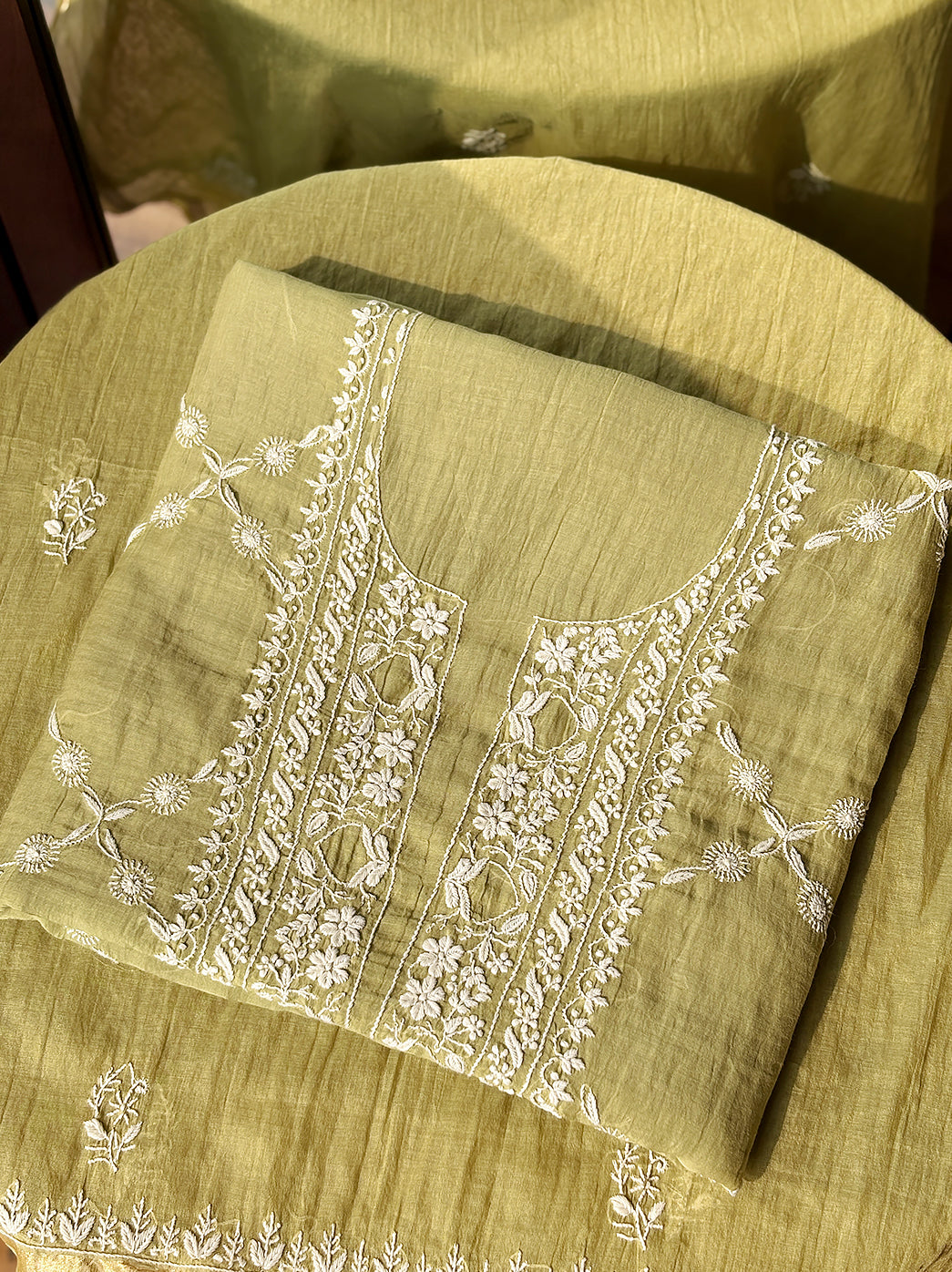 Artistic capture of trending Chikankari kurti piece made from Mul Chanderi fabric with detailed embroidery for product listing.