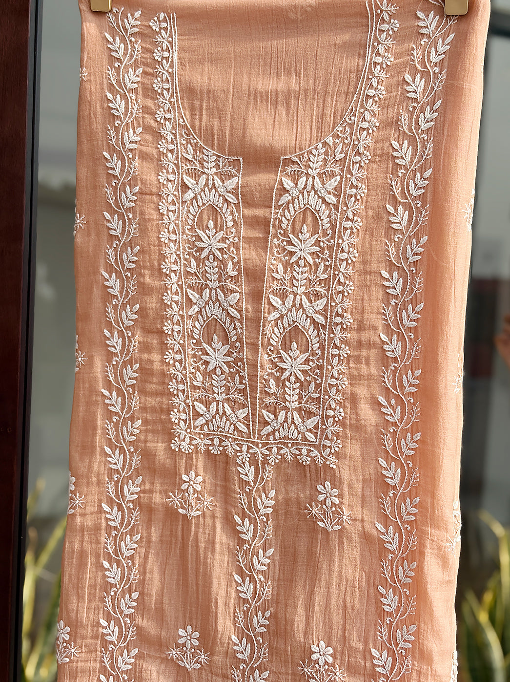 Mul Chanderi kurti piece with dupatta laid flat to highlight delicate hand-embroidered Chikankari floral designs and borders.