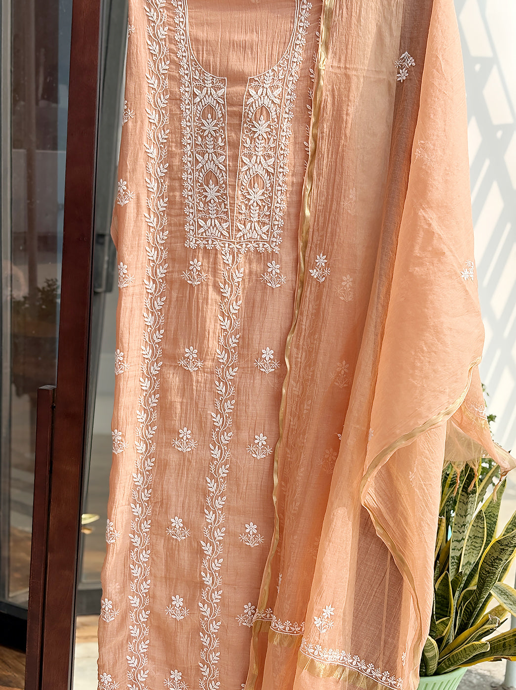 Artistic capture of trending Chikankari kurti piece made from Mul Chanderi fabric with detailed embroidery for product listing.