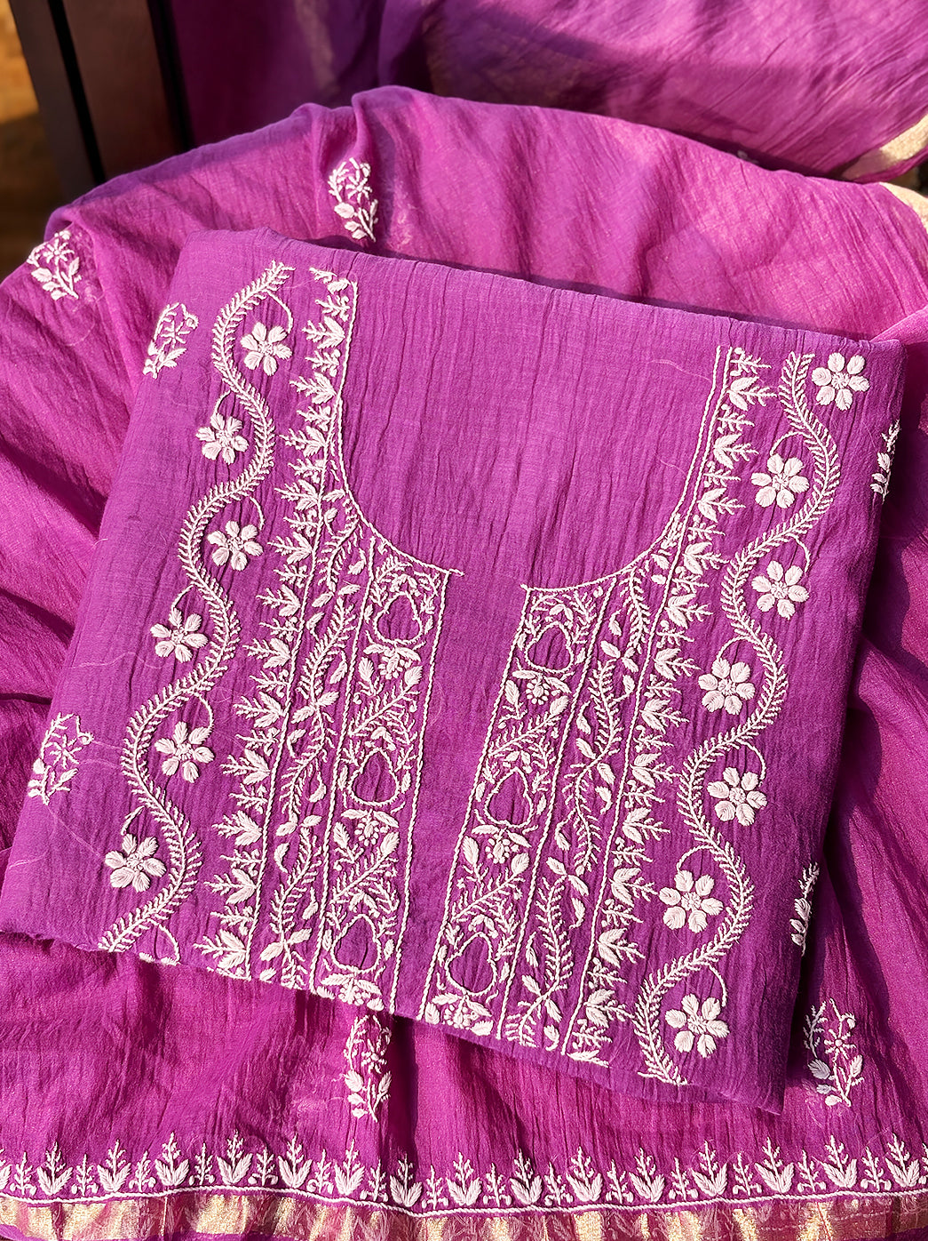 Soft Mul Chanderi kurti fabric with handcrafted Chikankari patterns arranged aesthetically for e-commerce product display.