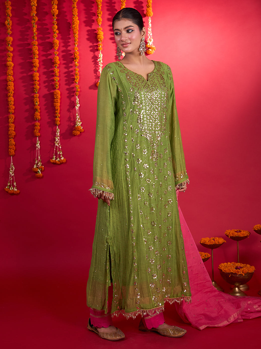 Long Chikankari kurta from the Tehzeeb Mul Chanderi set, styled with coordinating bottoms, traditional juttis and statement earrings for a festive occasion.