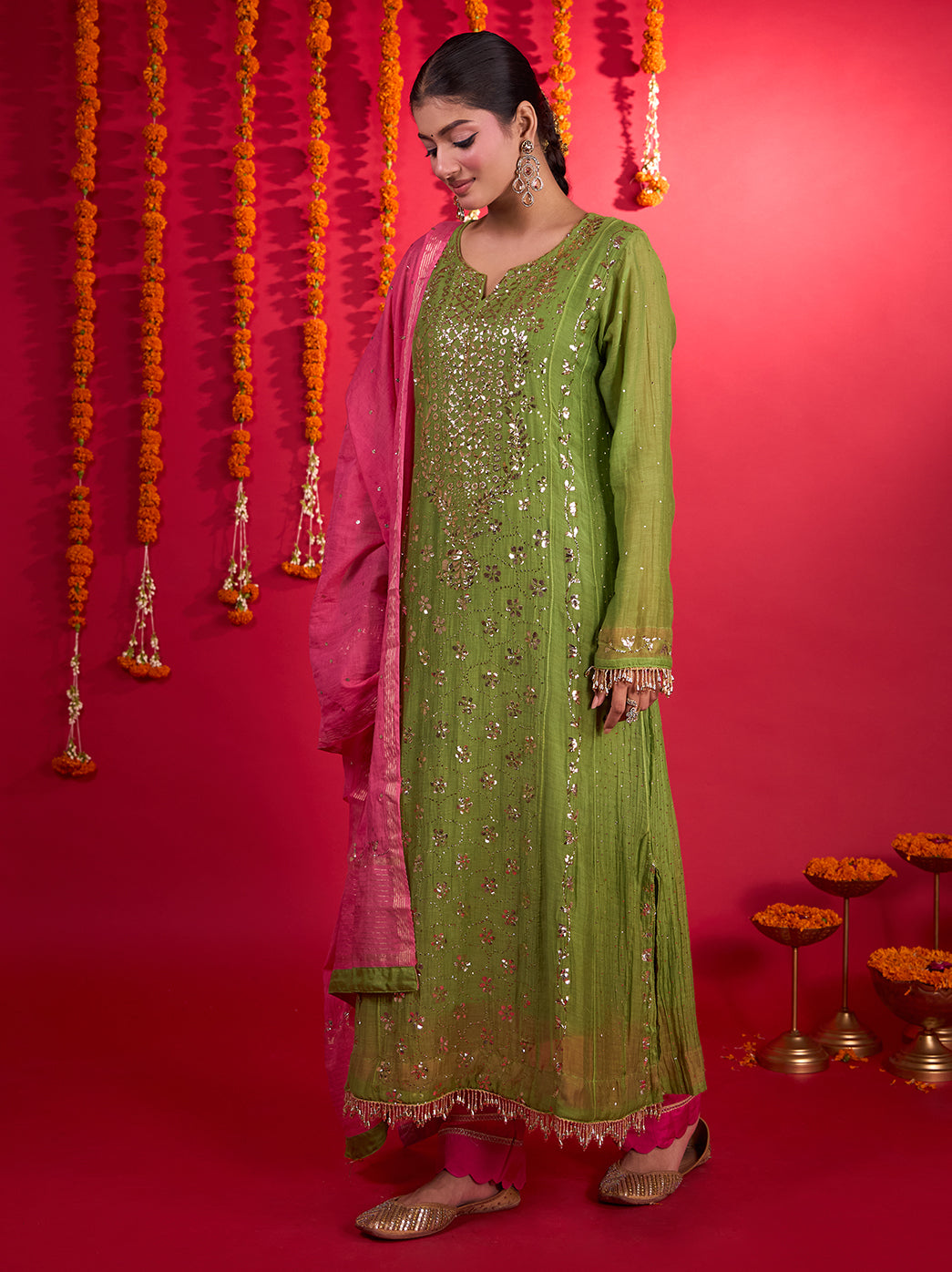 Tehzeeb Mul Chanderi festive wear set with a long embroidered kurta and a dupatta trailing beside the model, revealing its contrasting border and scattered embellishments.