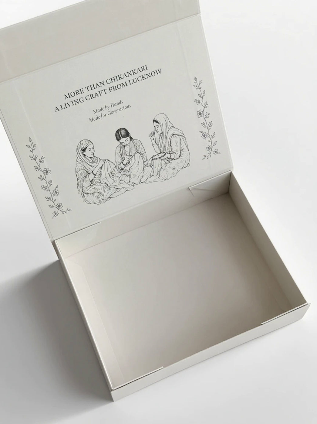 Angled view of the Chikanlabel Gift Box highlighting its broad rectangular lid, floral detailing and branded front panel with the website address.