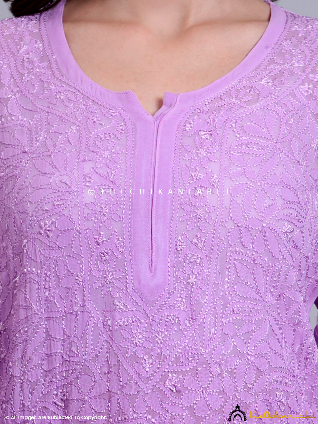 Side pose of model showcasing relaxed fit chikankari kurti with handcrafted floral patterns and side slit design.