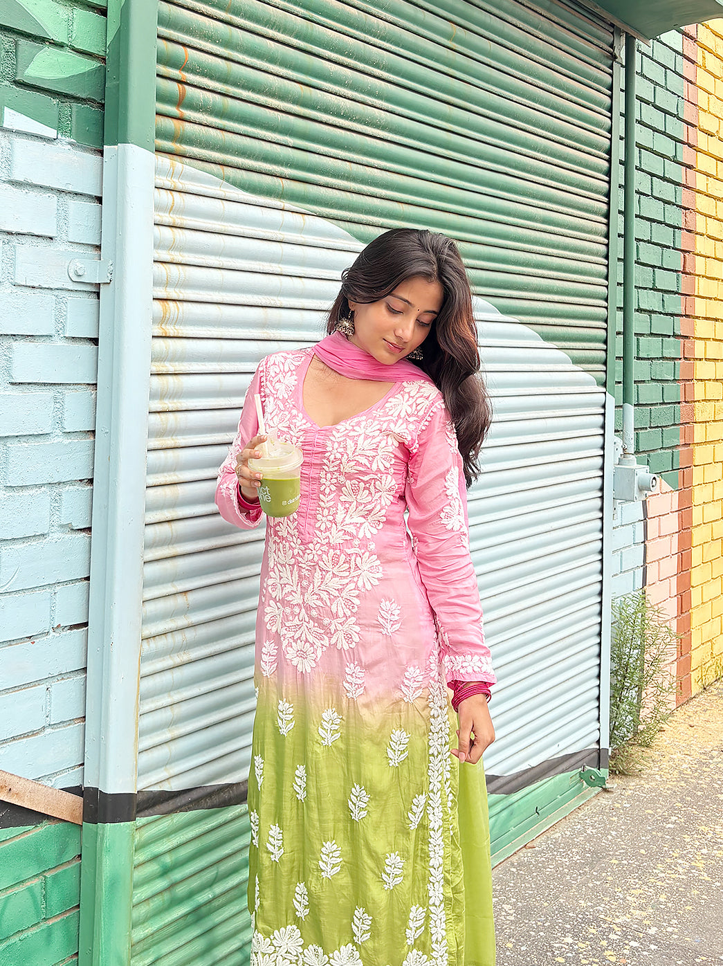 Full-length view of a woman styled in an embroidered Chikankari kurta set featuring a straight silhouette, floral motifs, comfortable bottoms and a soft dupatta.