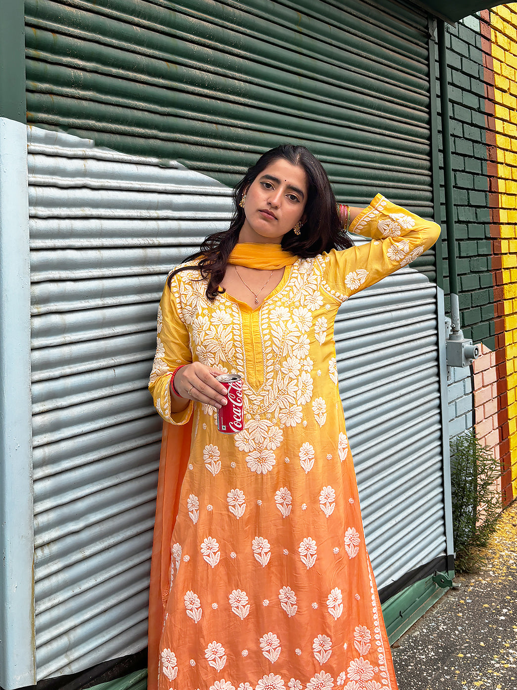 Model wearing a three-piece muslin straight kurta set with Chikankari embroidery, matching bottoms and dupatta for casual outings, festive wear and regular use.