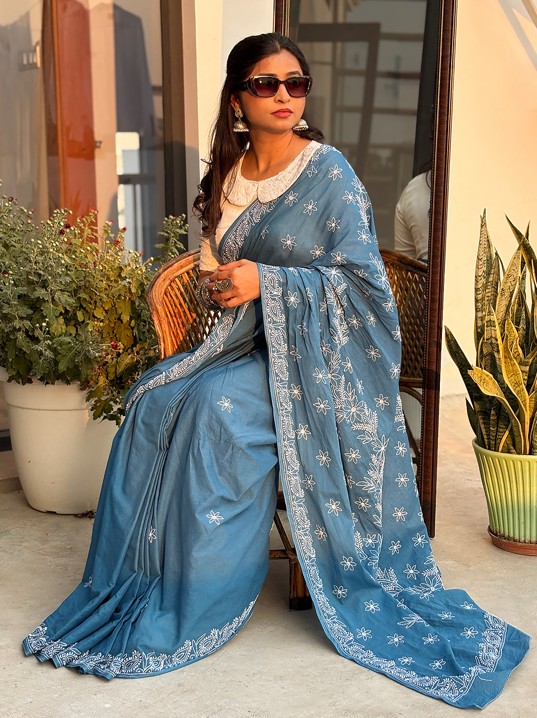 Mulmul cotton saree featuring handcrafted Chikankari embroidery with floral motifs and traditional Lucknowi detailing, styled for elegant ethnic wear.