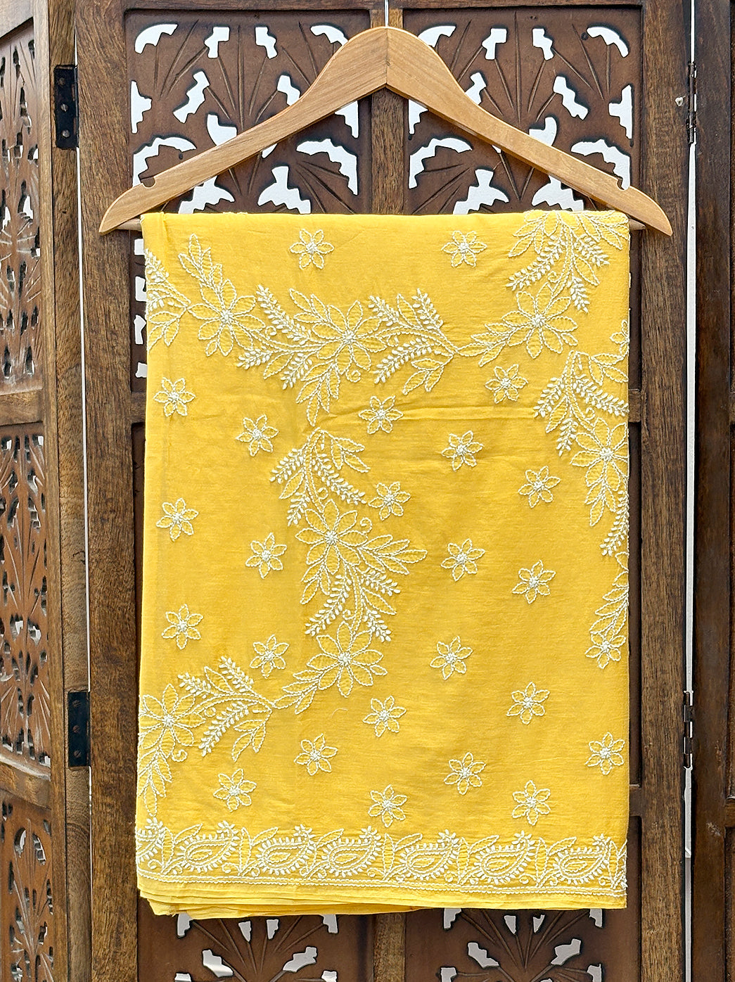 Mulmul cotton saree with detailed Chikankari embroidery and soft breathable texture, perfect for festive and cultural events.