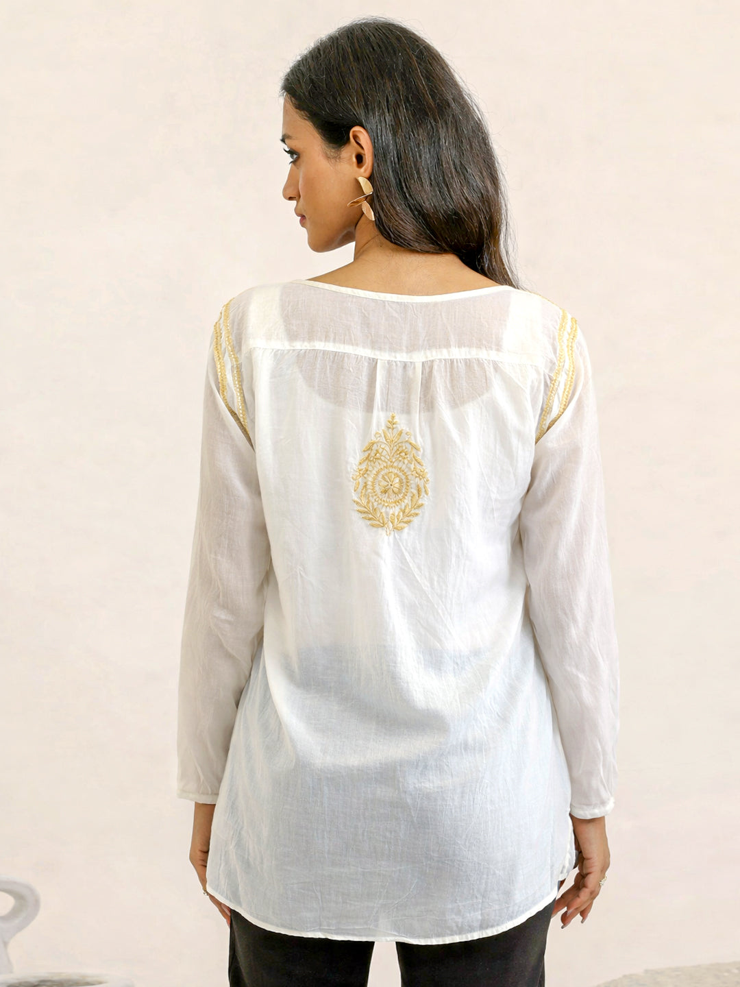 Ethnic chikankari kurti with fine thread embroidery on the front yoke, round neckline, and straight hemline designed for versatile wardrobe styling.