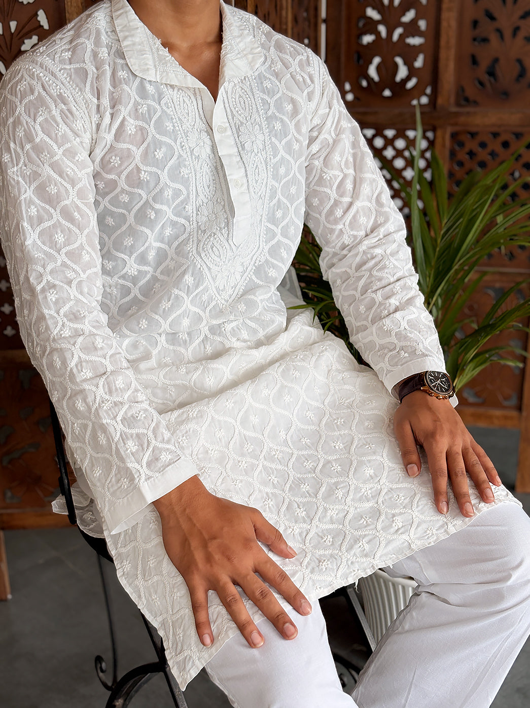 Front view of a Chikankari men’s kurta featuring intricate all-over embroidery, a straight silhouette and comfortable cotton fabric.