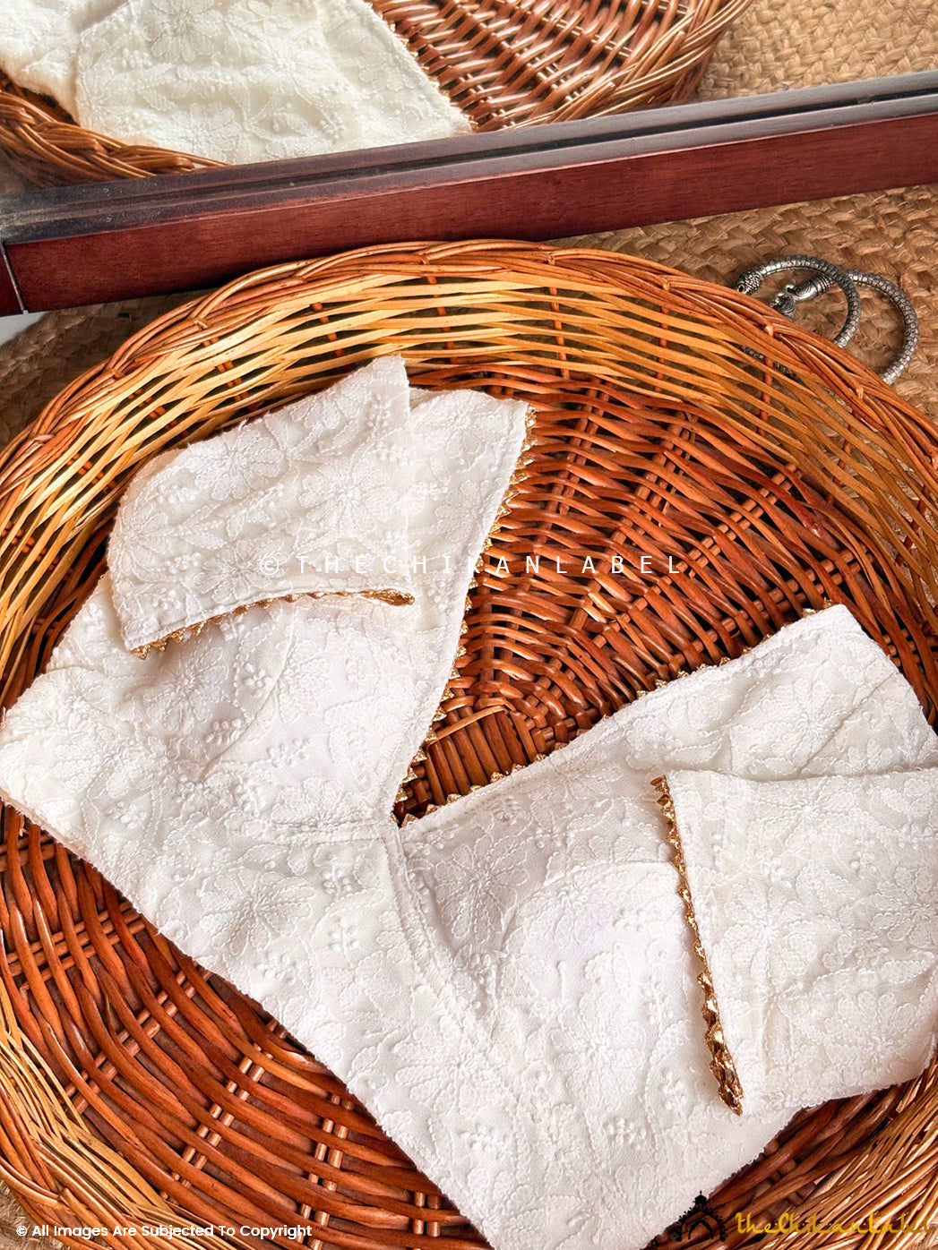 Traditional Indian Chikankari crop blouse featuring floral motifs and handcrafted detailing on sleeves and hem