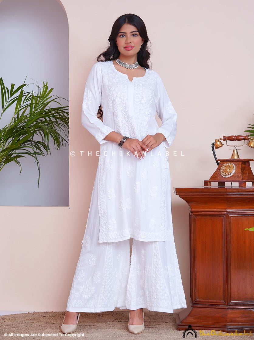 Woman wearing white chikankari kurti set with matching palazzo