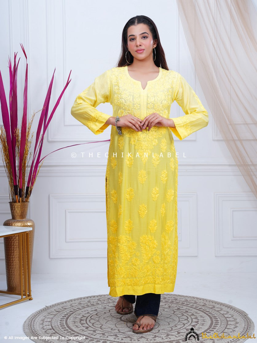 Woman wearing yellow Chikankari straight kurti with traditional embroidery