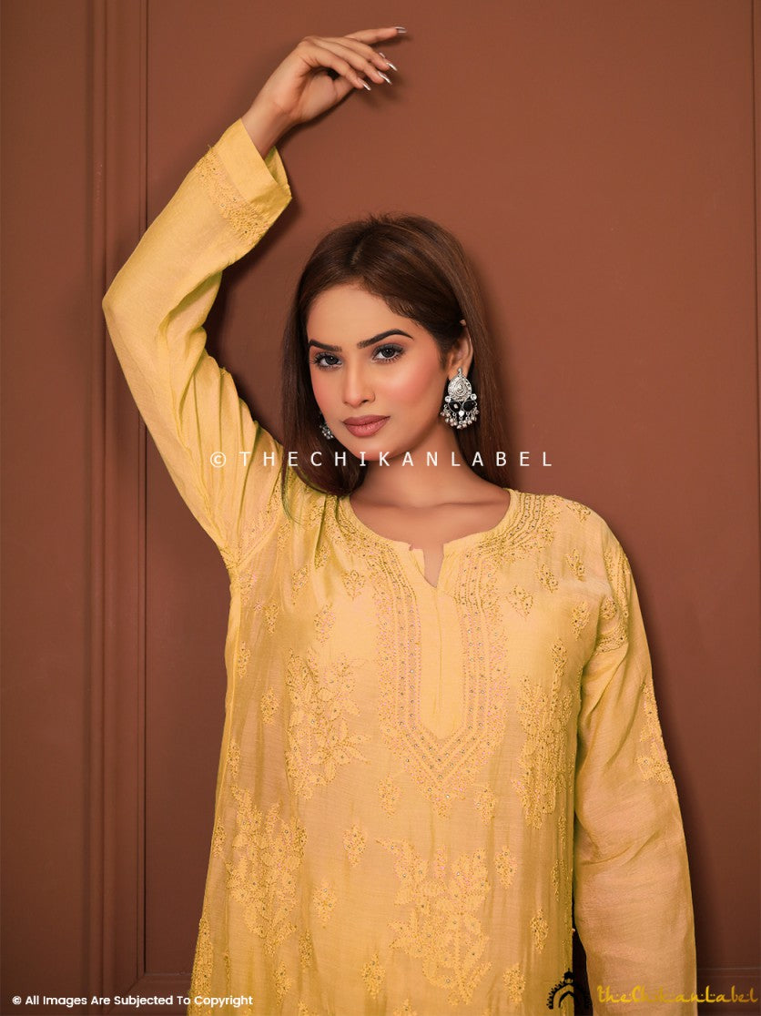 Traditional Lucknowi embroidered yellow suit set styled outdoors