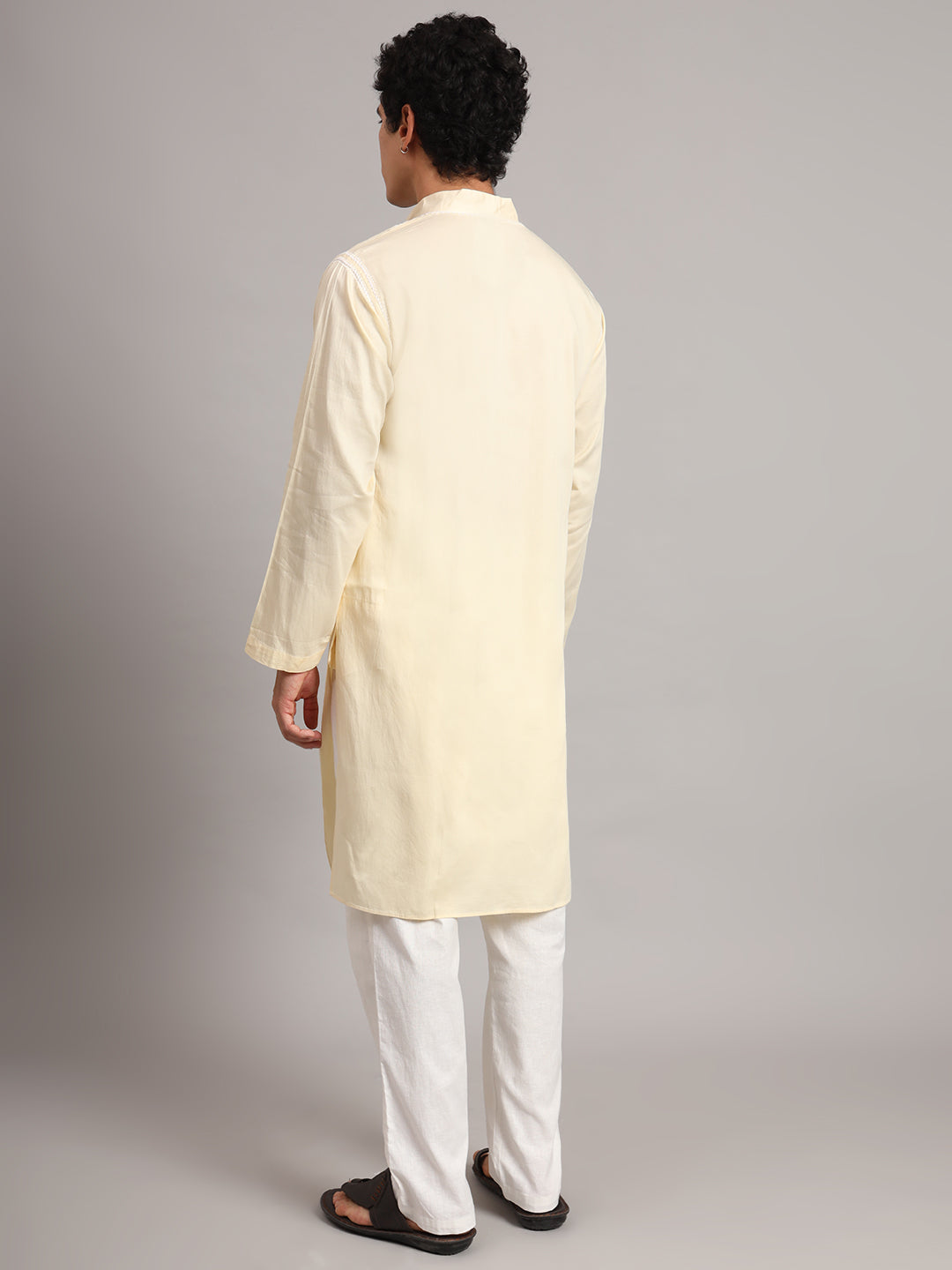 Uman Mens Kurta showing repeated floral and leaf motifs around the front opening, bordered by decorative threadwork that forms a pointed finish beneath the placket.