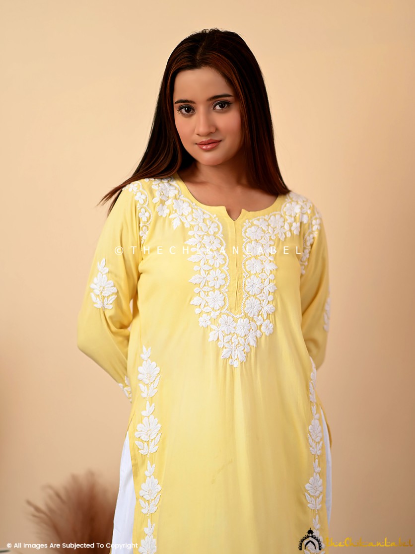Hand-embroidered yellow kurti in breathable rayon fabric featuring traditional Lucknowi motifs and a classic neckline.