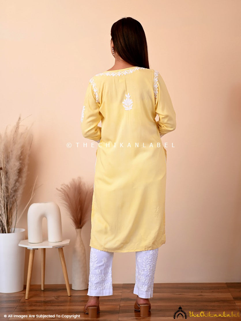 A-line yellow kurti with intricate white chikankari along neckline, sleeves, and hem, perfect for summer comfort.