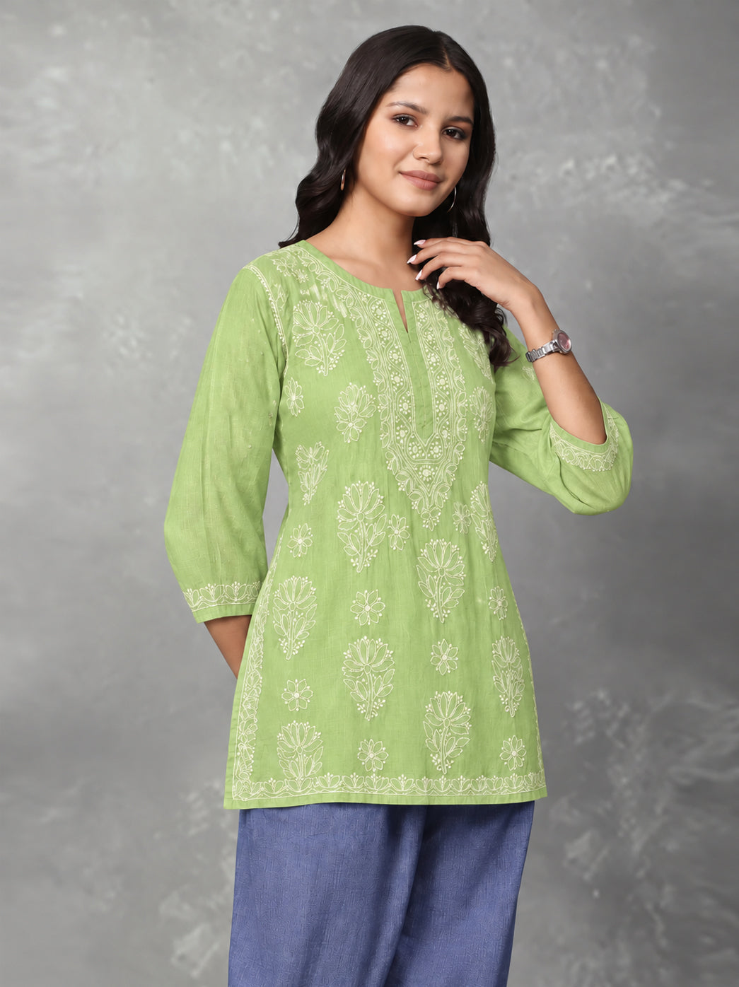 Ziva Cotton Short Kurti with three-quarter sleeves, showing floral embroidery on the upper sleeves and delicate decorative stitching near the cuffs.