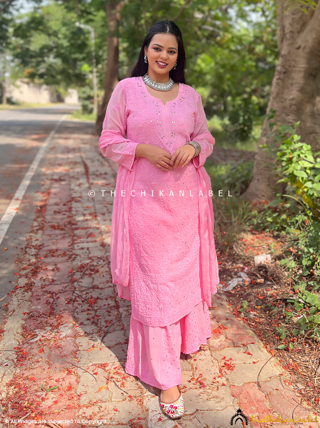 Woman wearing pink viscose chikankari kurta set with dupatta