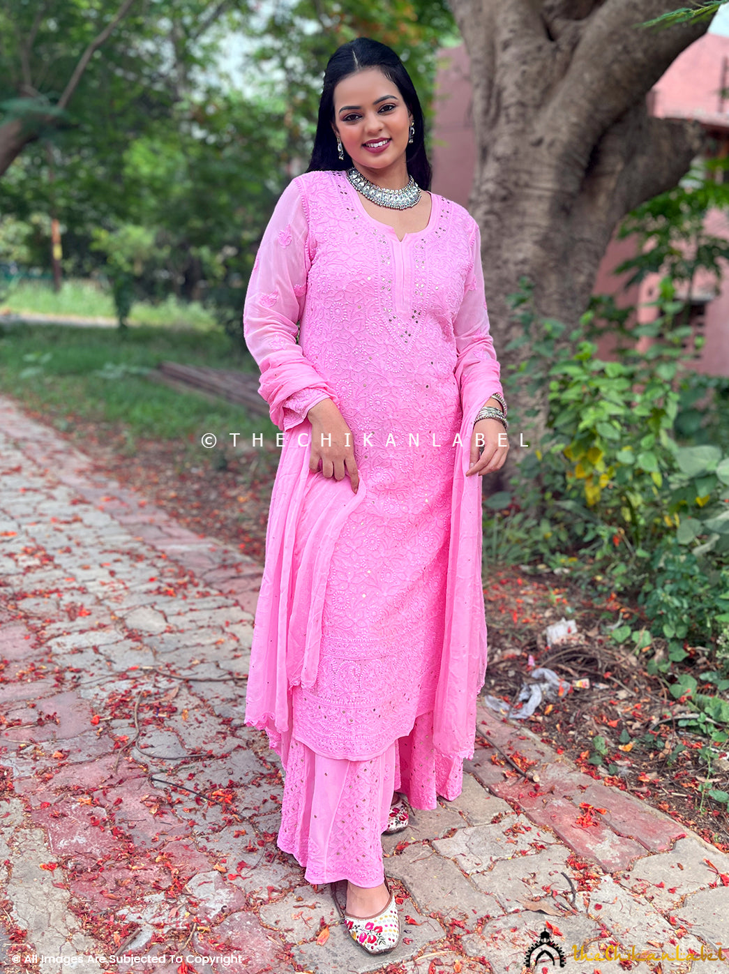 Hand-embroidered chikankari motifs on pink viscose fabric