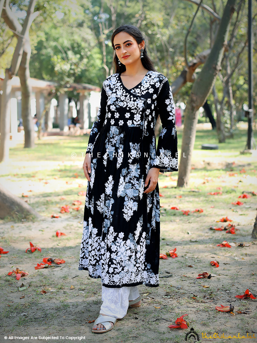 Woman wearing black angrakha chikankari kurta with white embroidery