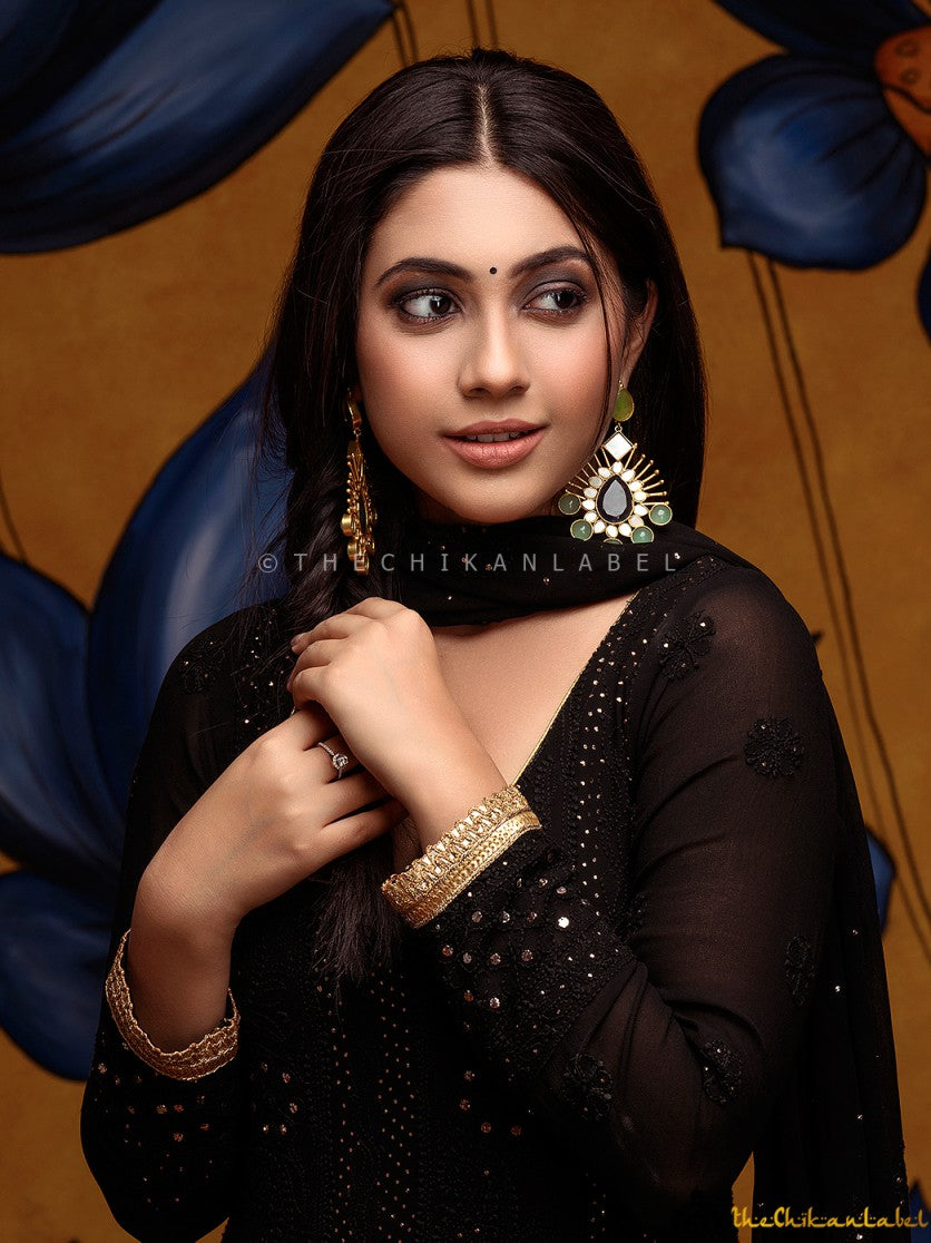 Designer mukaish Anarkali dress with rich flare and festive styling captured in natural light